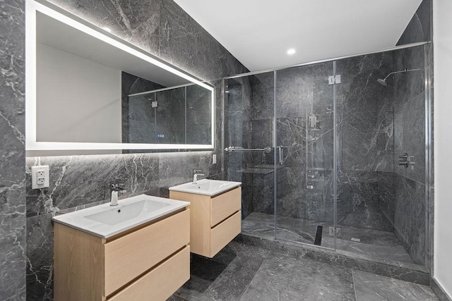 30-05 Vernon Blvd Ph-A, Ph-A New York City, NY 11102 - full bathroom with tile walls, marble tiled flooring, two vanities, a marble finish shower, and recessed lighting