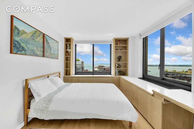 200 Rector Pl Unit 14E, New York City, NY 10280 - bedroom featuring wood finished floors and a water view