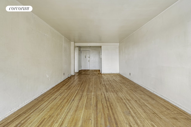 spare room featuring wood finished floors and visible vents