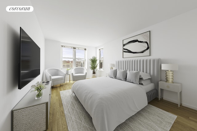 bedroom featuring wood finished floors, visible vents, and baseboards