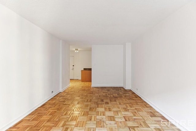 empty room featuring baseboards