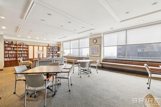 dining room with a raised ceiling and carpet floors