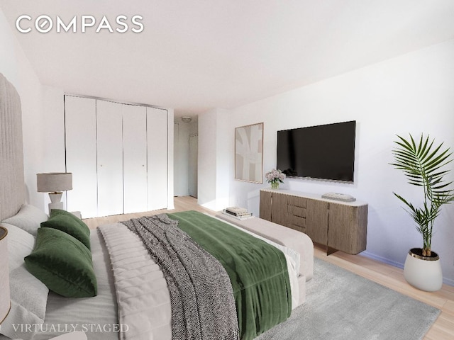 bedroom featuring a closet and light hardwood / wood-style flooring