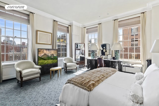 carpeted bedroom featuring crown molding