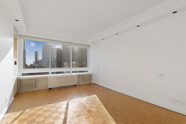 empty room with baseboards, ornamental molding, and a city view