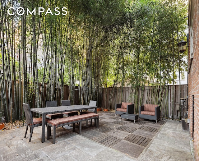 view of patio / terrace featuring outdoor dining space and a fenced backyard