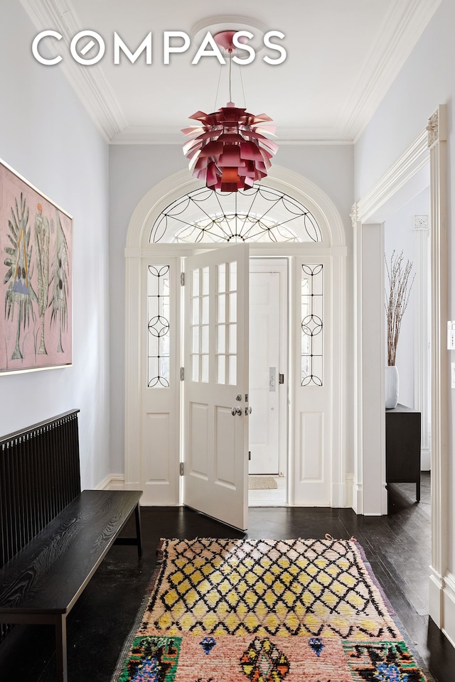 entryway with crown molding and dark wood-style floors