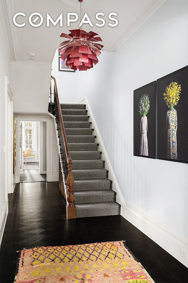 staircase featuring recessed lighting, wood finished floors, baseboards, and ornamental molding