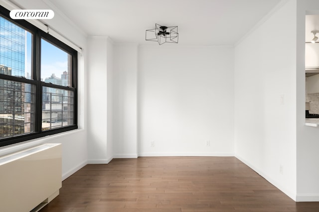 unfurnished dining area featuring hardwood / wood-style flooring and crown molding