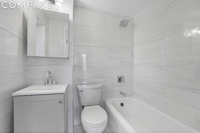 bathroom featuring tile walls, toilet, and vanity