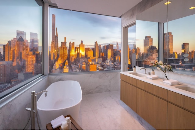 611 W 56th St Unit Ph30, New York City, NY 10019 - full bath featuring a view of skyline, a freestanding bath, marble finish floors, and double vanity