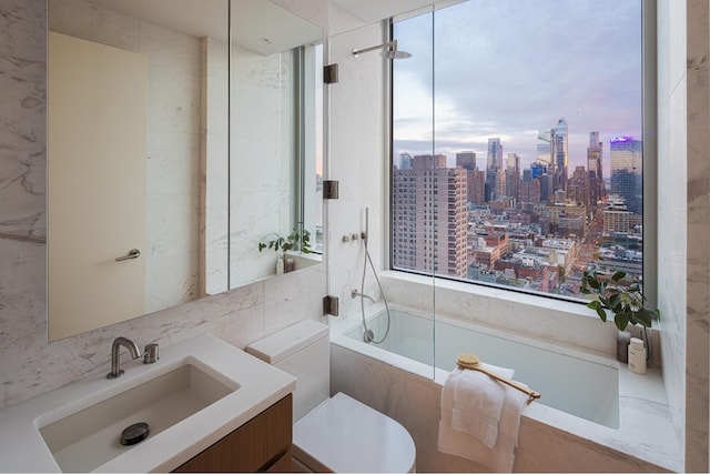 bathroom with a view of skyline, healthy amount of natural light, vanity, a combined bath / shower with marble appearance, and tile walls