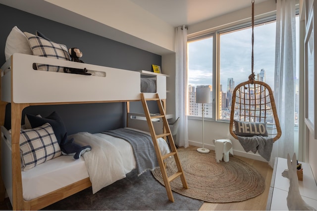 bedroom featuring multiple windows and a view of city