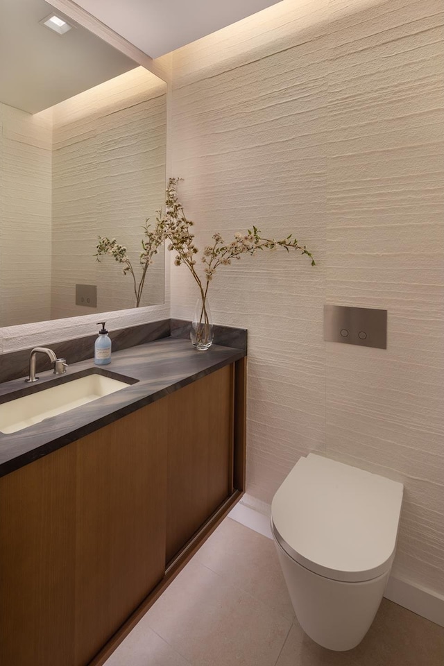 bathroom featuring toilet, vanity, and tile patterned floors