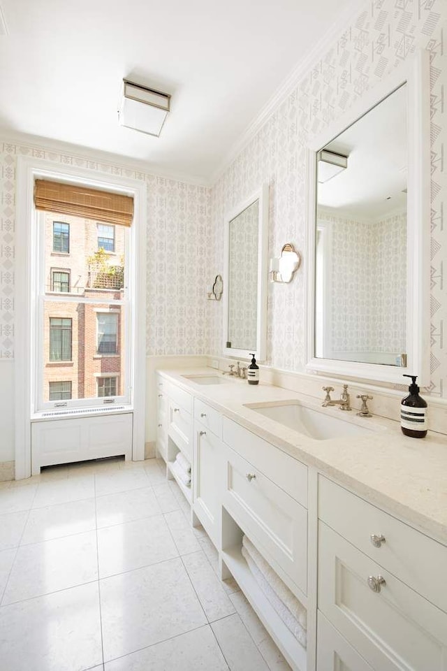 13 E 94th St, New York City, NY 10128 - bathroom with double vanity, wallpapered walls, ornamental molding, and tile patterned flooring