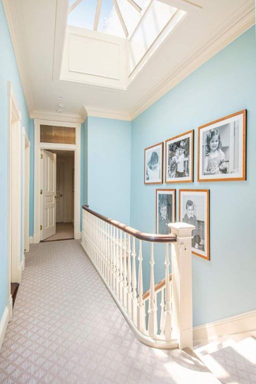 dining space with ornamental molding and light colored carpet