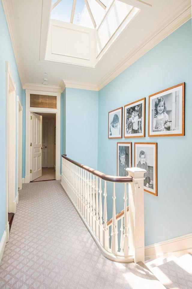 13 E 94th St, New York City, NY 10128 - hallway featuring an upstairs landing, carpet floors, crown molding, and a skylight