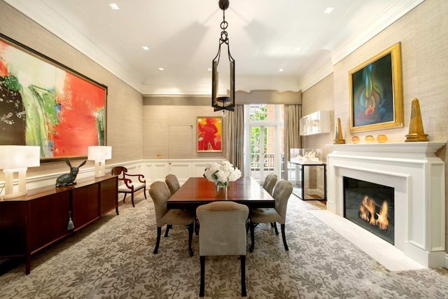 13 E 94th St, New York City, NY 10128 - carpeted dining area featuring crown molding, a fireplace with flush hearth, a wainscoted wall, a decorative wall, and wallpapered walls