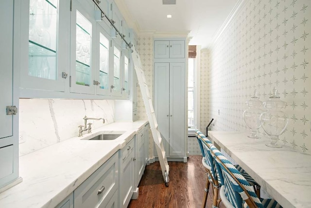 13 E 94th St, New York City, NY 10128 - bar featuring wallpapered walls, crown molding, and dark wood finished floors