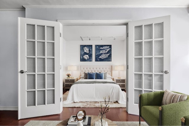 bedroom with track lighting and ornamental molding