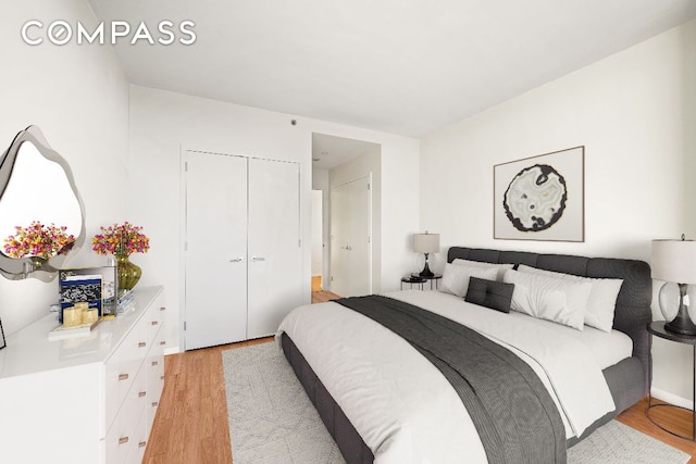 bedroom featuring light wood-style flooring and a closet