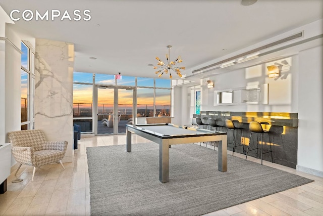 recreation room with expansive windows, billiards, light wood-style flooring, and an inviting chandelier