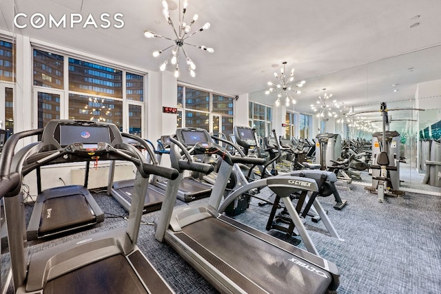 exercise room with a chandelier, carpet, and floor to ceiling windows