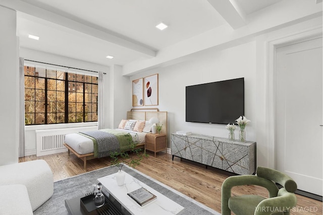 bedroom with beam ceiling and hardwood / wood-style flooring