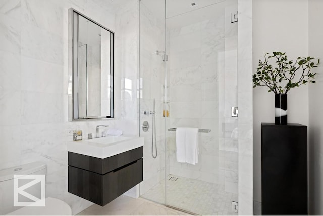 bathroom with vanity, an enclosed shower, and tile walls