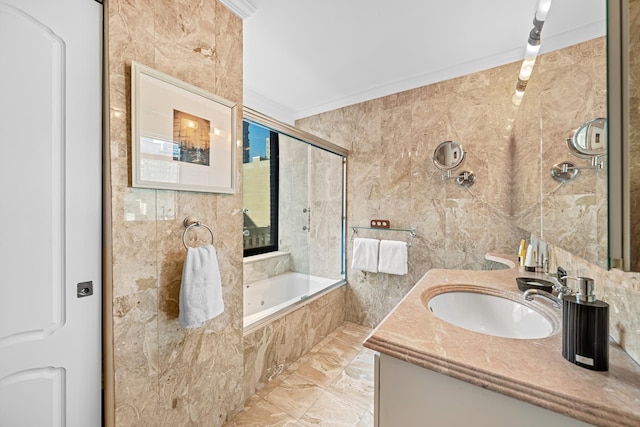 bathroom featuring crown molding, tile walls, vanity, and a bathing tub