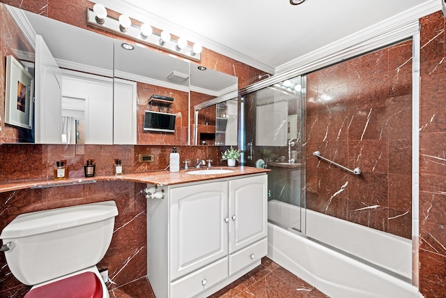 bathroom with tile walls, backsplash, toilet, ornamental molding, and vanity