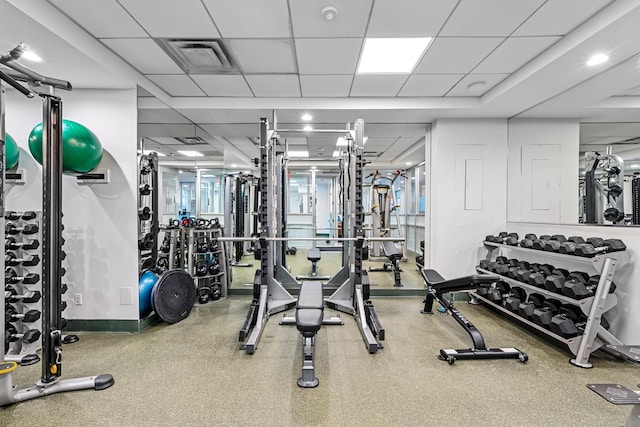 exercise room with visible vents and a paneled ceiling