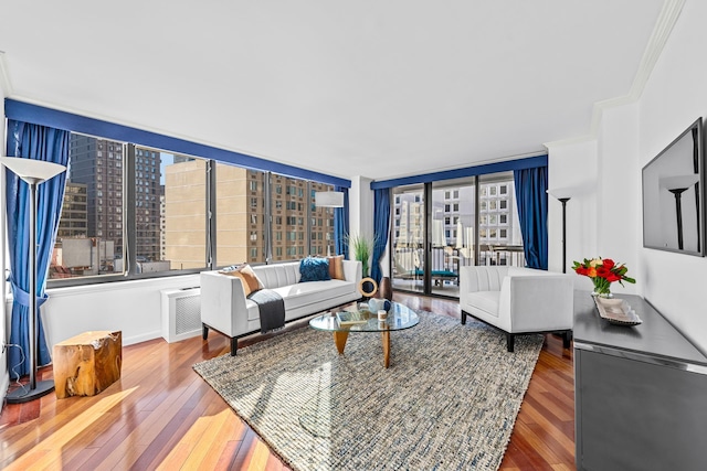 living area featuring ornamental molding and hardwood / wood-style flooring