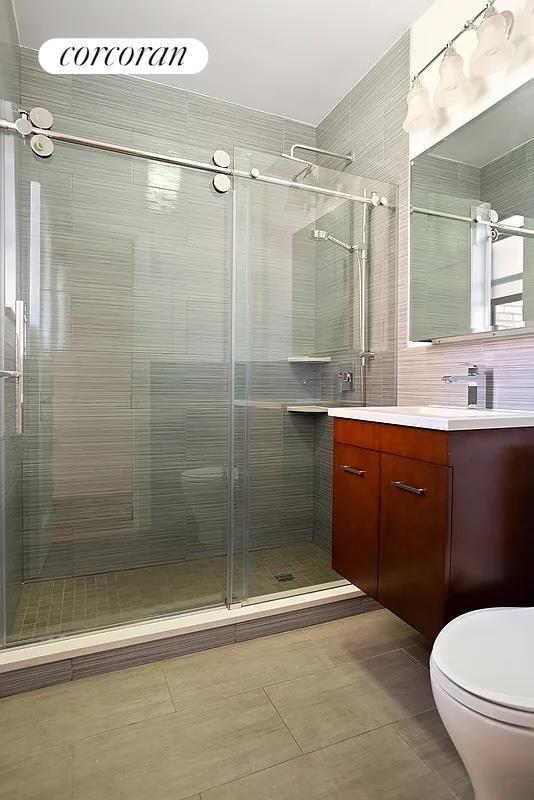 full bath featuring toilet, a shower stall, tile patterned flooring, and vanity