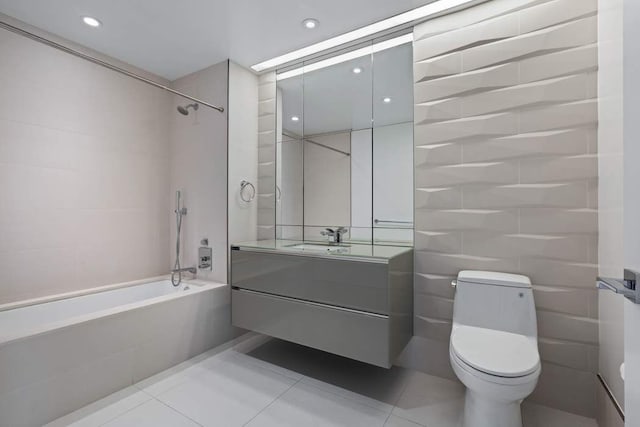 full bathroom with vanity, toilet, tile patterned flooring, and tiled shower / bath combo