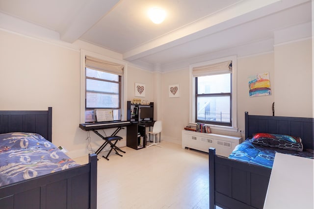 bedroom with beam ceiling, wood finished floors, and multiple windows