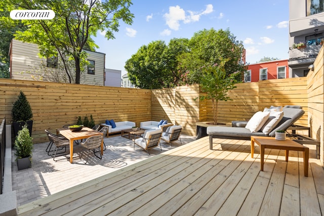 wooden deck with outdoor dining area, outdoor lounge area, and a fenced backyard