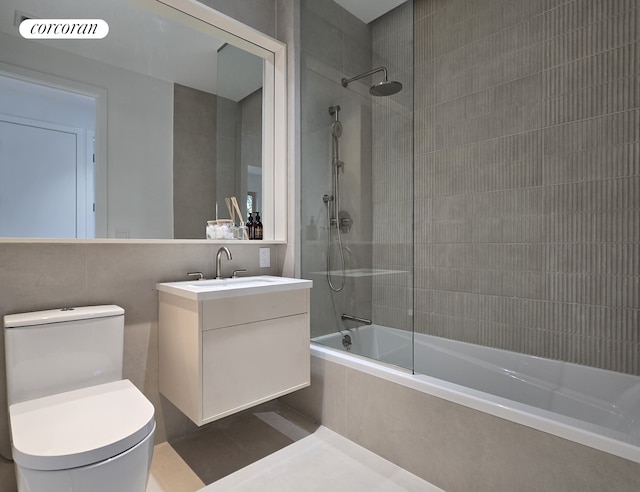 bathroom with tiled shower / bath, visible vents, vanity, and toilet