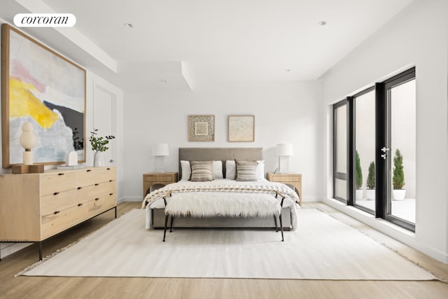 bedroom featuring access to outside and light wood-type flooring