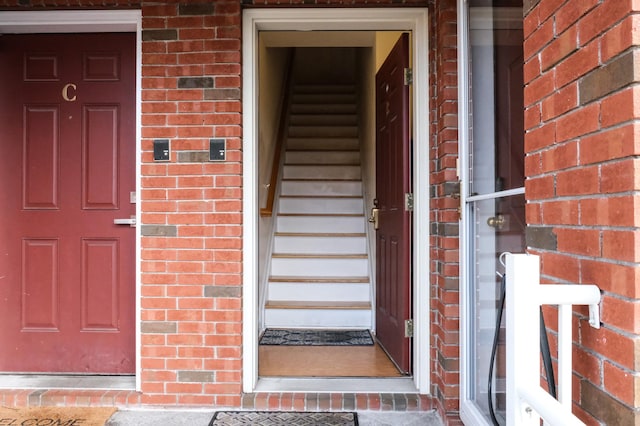 doorway to property with brick siding