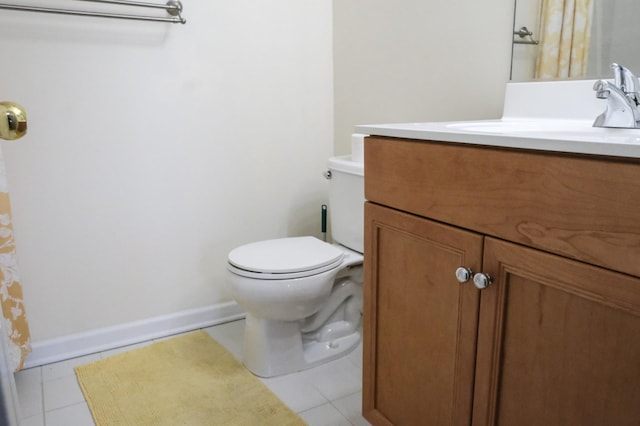 bathroom with tile patterned flooring, toilet, vanity, and baseboards