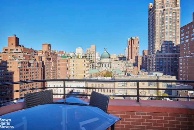 balcony with a view of city and outdoor dining area