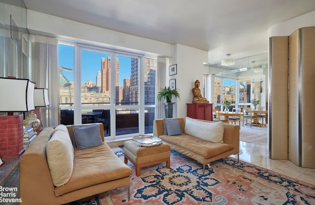 living area featuring light tile patterned floors and a view of city