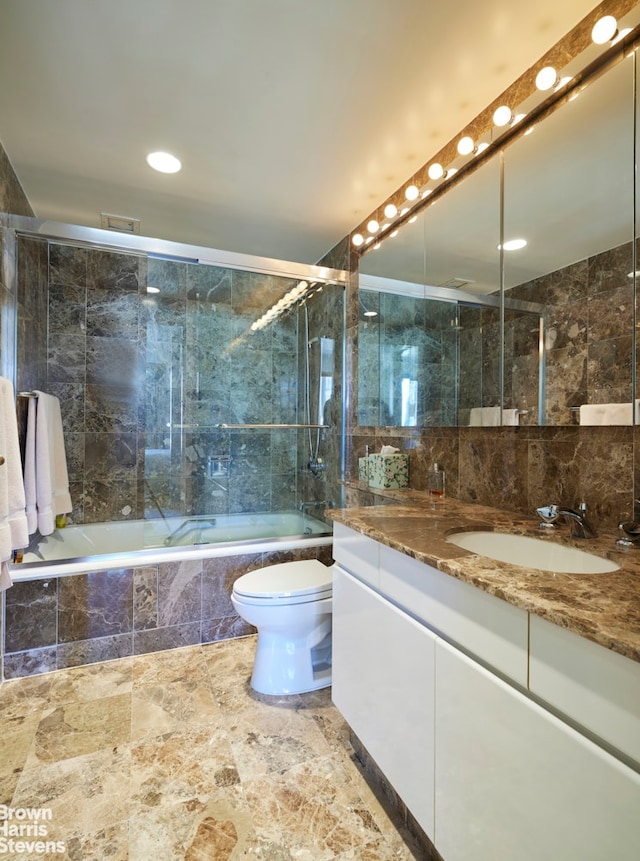 bathroom with vanity, recessed lighting, tiled shower / bath combo, and toilet