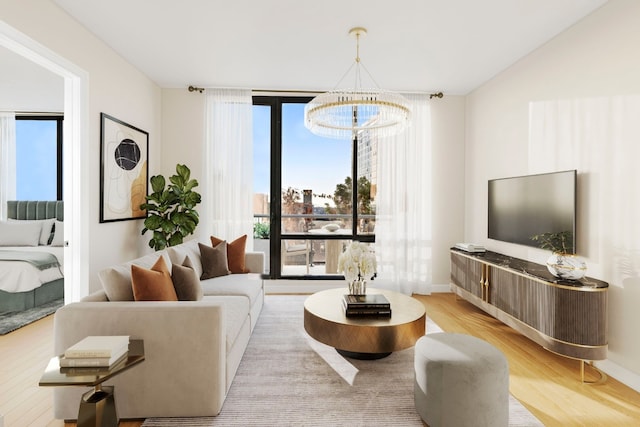 living room with an inviting chandelier, light hardwood / wood-style floors, and plenty of natural light