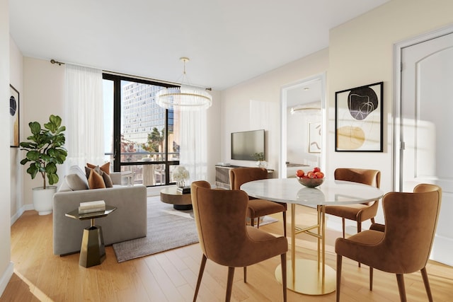 dining space with an inviting chandelier, light hardwood / wood-style floors, and expansive windows