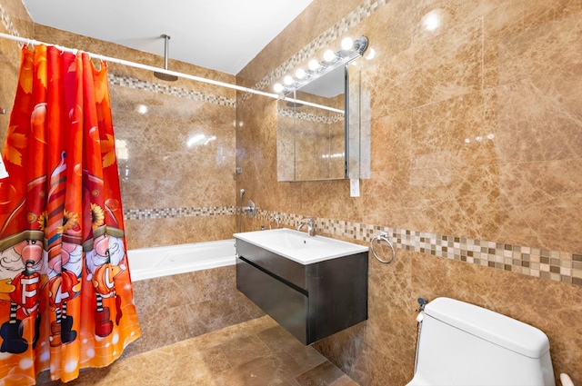 full bathroom featuring tile walls, toilet, vanity, and shower / bath combo