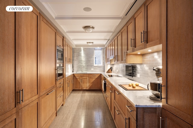 kitchen with built in microwave, stainless steel oven, sink, black electric cooktop, and decorative backsplash