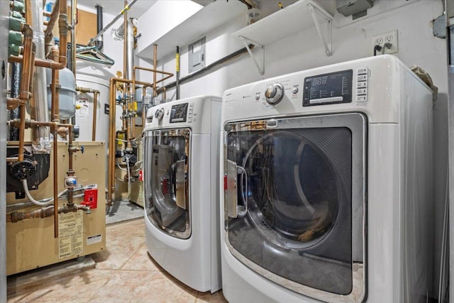 washroom featuring washing machine and clothes dryer and light tile patterned flooring