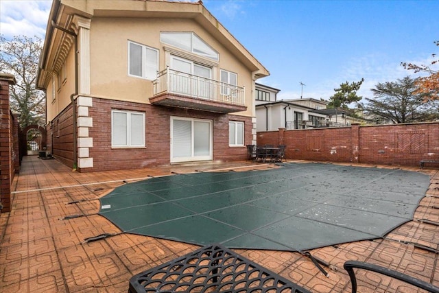 back of house with a balcony and a patio area